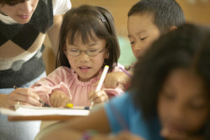 Young girl working in classroom